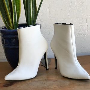 White pointed toe ankle heeled boots
